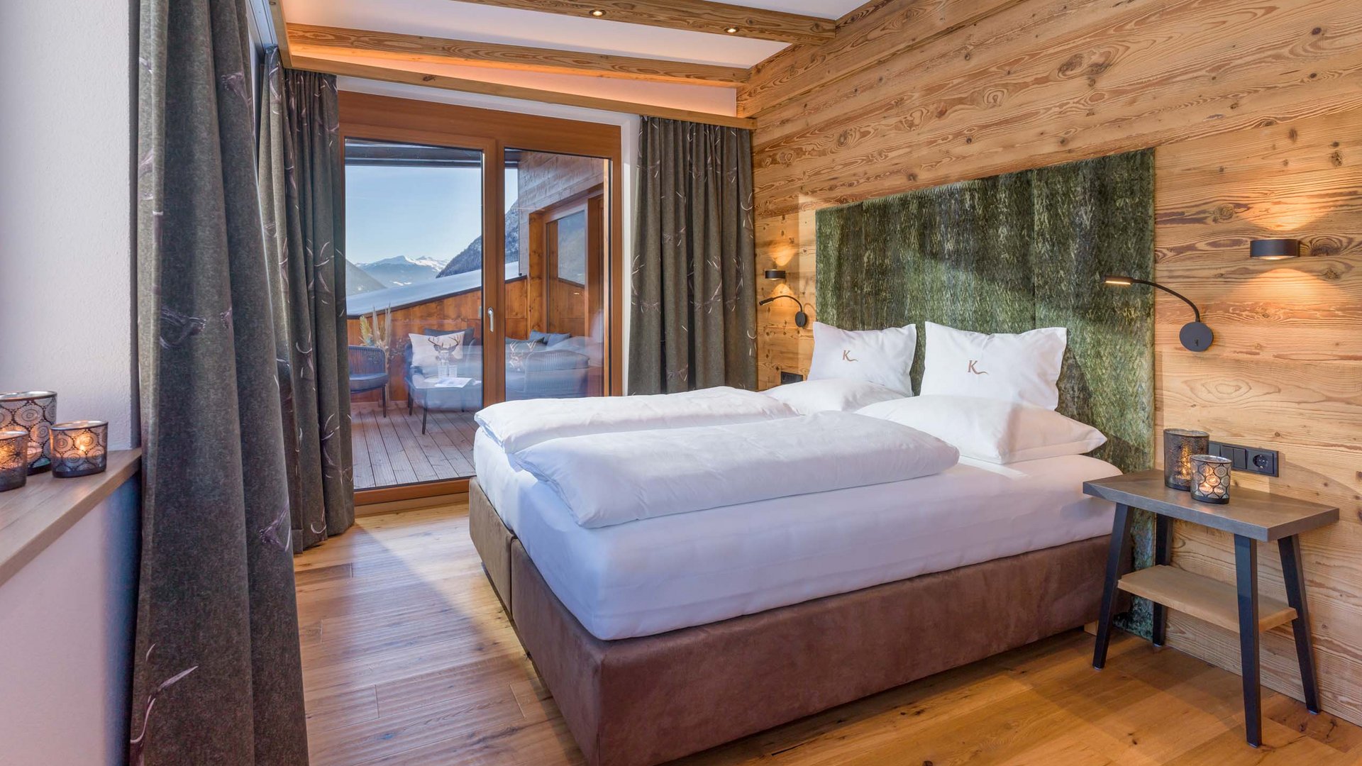 Hotel on Lake Achensee? The Karlwirt! Cozy bedroom with wooden walls and view of balcony and mountains