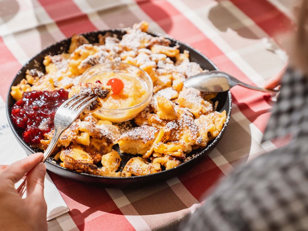 Our Langlaufstüberl in Pertisau Person eating Kaiserschmarrn with applesauce and lingonberry jam from pan